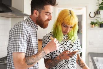 Two people looking at a phone Two people looking at a phone